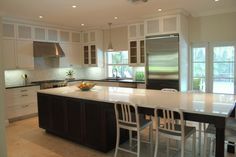 a large kitchen with an island in the middle