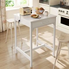 a kitchen table with bread on it and two chairs in front of the counter top