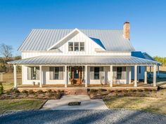 a large white house with a metal roof