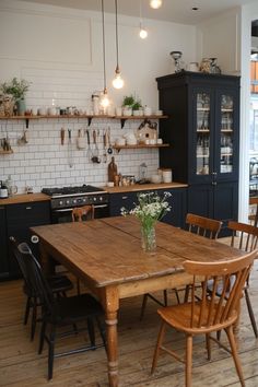 a wooden table sitting in the middle of a kitchen