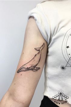 a whale tattoo on the left arm