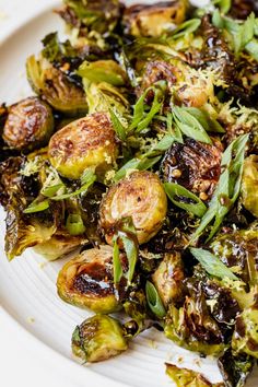 a white plate topped with brussel sprouts and cheese