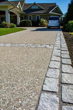 a blue van is parked in front of a house with stone walkways and grass