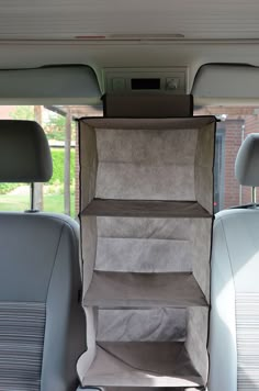 the back seat of a car with several shelves in it's rear end area