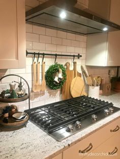 a stove top oven sitting in a kitchen next to a counter with utensils on it