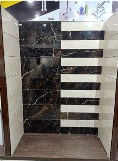 a shower with marble walls and flooring in a store display area at a mall