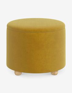 a round ottoman with wooden legs and a mustard colored upholstered cover on it