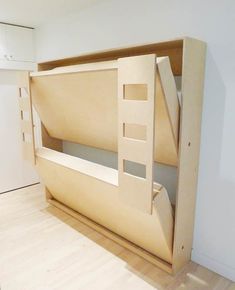 there is a bunk bed built into the wall with no mattresses or sheets on it