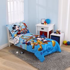 a child's bedroom with mickey mouse bedding