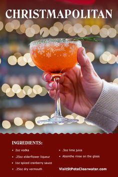 a person holding a wine glass in front of a christmas tree with lights behind it