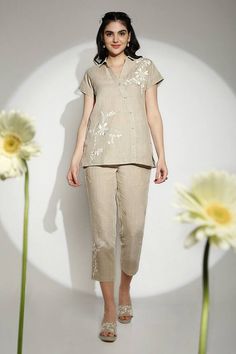 Natural beige top embellished with florals using Bas Relief technique, intricately embroidered by hand with anchor thread embroidery, muted gold-toned foil, and edged with hand-spray-painted gold organza flowers. - Aza Fashions Embroidered Beige Linen Top, Beige Embroidered Linen Top, Beige Linen Tops With Floral Embroidery, Elegant Beige Floral Embroidered Top, Elegant Beige Top With Chikankari Embroidery, Elegant Beige Tops With Chikankari Embroidery, Elegant Linen Tops With Floral Embroidery, Beige Wedding Tops With Floral Embroidery, Elegant Linen Sets With Floral Embroidery