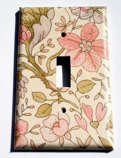 a light switch cover with flowers on it