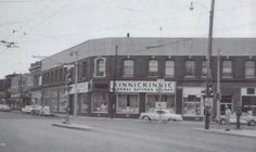 an old black and white photo of a street corner