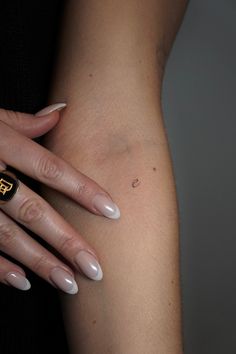 a woman's arm with a ring on it