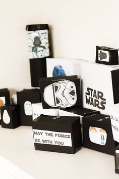 star wars themed items are displayed on a shelf in a room with white walls and black boxes