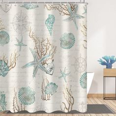 a shower curtain with sea shells and seashells on it in a bathroom setting