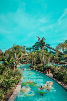 the water park is filled with people and rides