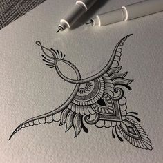 an ink drawing of a bird on paper next to two markers and a ballpoint pen