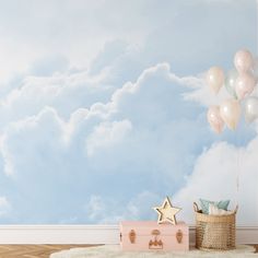 there is a suitcase and some balloons on the floor in front of a blue sky with white clouds