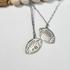 This stunning Football Necklace makes the perfect personalized gift, or team Mom gift, celebrating the passion of the sport!  Ideal as a thoughtful present for Football Moms.  These make a great Christmas gift or stocking stuffer. 𝐃𝐄𝐓𝐀𝐈𝐋𝐒 *each necklace comes with a 17.5" long chain with 2" extender *charm is approximately 1" *personalizing available on one or both sides 𝐇𝐎𝐖 𝐇𝐎𝐖 𝐓𝐎 𝐎𝐑𝐃𝐄𝐑 *select desired color in drop down menu *in the personalization box add the number, name or word you would like marked *add to cart *repeat as necessary for additional necklaces 𝐂𝐇𝐄𝐂𝐊 𝐎𝐔𝐓 𝐌𝐘 𝐎𝐓𝐇𝐄𝐑 𝐋𝐈𝐒𝐓𝐈𝐍𝐆𝐒 🌟 Everything I Am Collection https://humblehippodesigns.etsy.com/listing/986033449/gift-for-mom-gift-dad-gifts-for-parents 🌟 Wristlet Keychain https://humbleh Football Xmas Gifts, Football Theme Christmas Gifts, Football Team Christmas Gifts, Gifts For Football Players, How How, Mom Gifts Christmas, Team Mom Gifts, Football Moms, Engraved Pencils