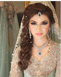 a woman with long hair wearing a bridal outfit