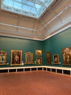 an empty room with paintings on the wall