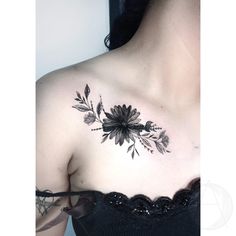 a woman's chest with flowers and leaves tattooed on her left side breast piece