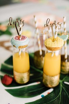 small jars filled with drinks on top of a table