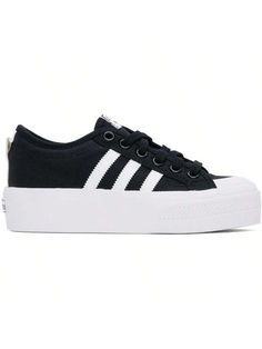 adidas Originals 
Black & White Nizza Platform Sneakers 
Low-top canvas sneakers in black and white. 
. Textured rubber cap toe 
. Lace-up closure 
. Logo patch at tongue 
. Padded collar 
. Faux-leather signature serrated stripes at sides 
. Eyelet vents at inner side 
. Pull-loop at heel collar 
. EVA sockliner 
. Rubberized logo patch at heel 
. Treaded vulcanized rubber platform sole 
. Platform: H1.75" 
Supplier color: Core black/Cloud white/Cloud white 
Upper: textile. Sole: rubber. 
Made Shoe List, Adidas Nizza Platform, Adidas Nizza, Color Core, Casual Athletic Shoes, Adidas Athletic Shoes, Shoes Outfit, Outdoor Bag, Casual Sneakers Women