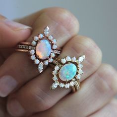 Our signature design is recreated with a stunning Australian opal and diamonds making it the dreamiest of all ring sets and goes by the name of Serena. Perfect engagement or wedding ring set for lovers of special rings.
 The price is for the complete ring set (all three rings).
Details
Solitaire ring


Main stone: Australian oval opal


Measurements: approx. 9x7 mm


Band stones: white diamonds


Quality: color grade G, clarity grade VS, conflict-free


Diamonds measurements: approx. 1.25 mm (12 Pastel Ring, Oval Opal Ring, Unique Bridal Jewelry, Australian Opal Ring, Diamond Bridal Ring Sets, Fine Gold Jewelry, Rainbow Opal, Opal Engagement Ring, Three Rings