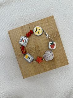 a wooden board with some charms on it