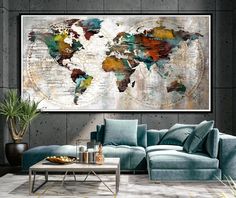 a living room with a couch, coffee table and large map on the wall above it