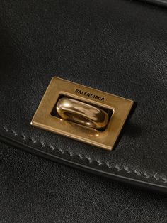 Find BALENCIAGA Rodeo Mini Leather Tote on Editorialist. The Balenciaga Rodeo tote is crafted from soft leather and features gold-tone hardware. The bag has a detachable shoulder strap, a top handle, and a turn lock closure. The interior has multiple compartments and is large enough to carry a cardholder, phone, and keys. It is a mini bag. Designer Gold Shoulder Bag With Brass Hardware, Gold Leather Shoulder Bag With Brass Hardware, Formal Yellow Gold Bag With Gold-tone Logo Plaque, Designer Yellow Gold Rectangular Shoulder Bag, Elegant Yellow Gold Leather Bag, Gold Leather Bag For Work, Gold Leather Bag For Workwear, High-end Gold Shoulder Bag For Everyday, Luxury Gold Bag For Business