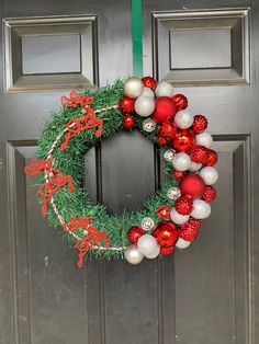 a christmas wreath hanging on the front door