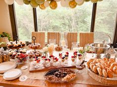 a table filled with lots of food and desserts