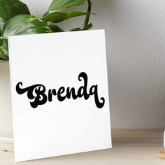 a white card with the word brenda written in black ink