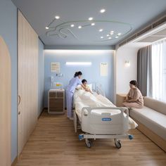 two people in a hospital room with beds