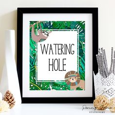 a framed poster with a sloth on it next to some pine cones and other decorations