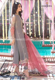 Pakistani Grey Eid Salwar Kameez Designer Dress offers a classic mix of trend and tradition both. A square armhole long length kurta is festooned with filigree embroidery done on shadow gray organza with dusty pink and teal thread highlighted by light gold zari and sequins. This design comes with a sprinkled chan organza dupatta with dyed silk pants. Shirt: Pakistani Eid dress comes in grey color, the design of the shirt is long kameez which is topped with a slim embroidered neckline and hemline Long Kameez With Capri, Eid Salwar Kameez, Long Kameez, Dress Design Pakistani, Eid Dresses, Fancy Dress Design, Organza Dupatta, Embroidered Neckline, Silk Pants