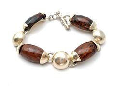 Fine Gemstone Jewelry - This is a sterling silver link bracelet with brown and black jasper gemstones. It is 7.5" long .5" wide and weighs 37.3 grams, hallmarked 925 Mexico. Earthy Brown Multi-strand Jewelry, Brown Multi-strand Hand-wrapped Bracelets, Bohemian Brown Multi-strand Bracelets, Brown Multi-strand Jewelry With Gemstone Beads, Multi-strand Brown Jewelry With Gemstone Beads, Silver Link Bracelet, Jasper Gemstone, Vintage Brown, Link Bracelets