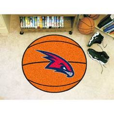 a basketball and shoes on the floor in front of a bookshelf with sports equipment