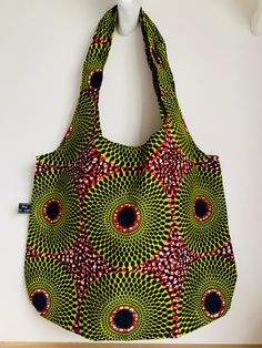 This fabric shopper is made out of a classic African print in a beautiful red and line green colour way.  I make each pattern of Polly Bags in small quantities and the inspiration is always the design of the fabric used. I have been making and selling these bags for several years now and the feed back from owners is that they are very strong, versatile and they last!   Buyers come back for more for themselves or they buy them as gifts for others.   The bag is unlined and measures 20 inches (51cm Eco-friendly Red Reusable Bag, Red Reusable Everyday Bag, Red Reusable Bag For Daily Use, Green Reversible Bag For Daily Use, Eco-friendly Red Shoulder Bag For Shopping, Eco-friendly Red Bag For Everyday Use, Eco-friendly Red Everyday Bag, Eco-friendly Red Bags For Everyday Use, Red Reusable Shopping Bag