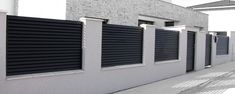 a row of black and white shutters on the side of a building