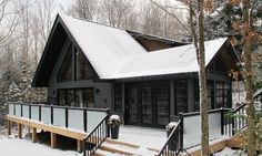 a house with snow on the ground and stairs leading to it