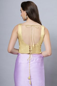 Our Satin Comfort Stretch collection blouses are made to impress and made to be worn all day. Made from the finest satin-cotton blend stretchable fabric, it holds its shape and shine while offering the comfort of stretchable material. Wear it with your favorite saree, as a crop top or lehenga choli! Item Type: Saree blouse / Crop top Product Features: Color: Gold Fabric: Satin Stretch Trim: Back Dori Neck Style: U, Front & Back Sleeve Length: Sleeveless Closure: Adjustable Criss Cross Padded: No Elegant Gold Sleeveless Camisole, Elegant Gold Sleeveless Blouse Tank Top, Gold Blouse Piece For Summer, Gold Summer Blouse Piece, Elegant Fitted Gold Camisole, Sleeveless Silk Stretch Top, Elegant Stretch Tank Blouse, Fitted Cotton Camisole Blouse, Elegant Sleeveless Gold Vest