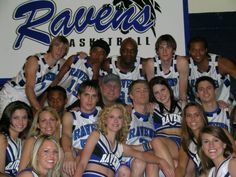 a group of young people posing for a photo in front of a sign that reads raven's basketball