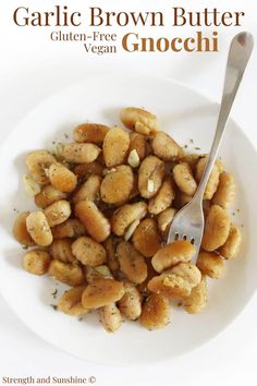 garlic brown butter gnocchini on a white plate with a fork in it