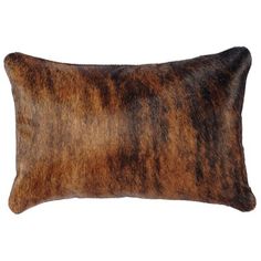 a brown and black animal skin pillow on a white background with clipping for text