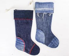 two pairs of blue jeans with red stitchs on them and one pair of socks