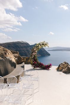 an outdoor ceremony setup with chairs and flowers